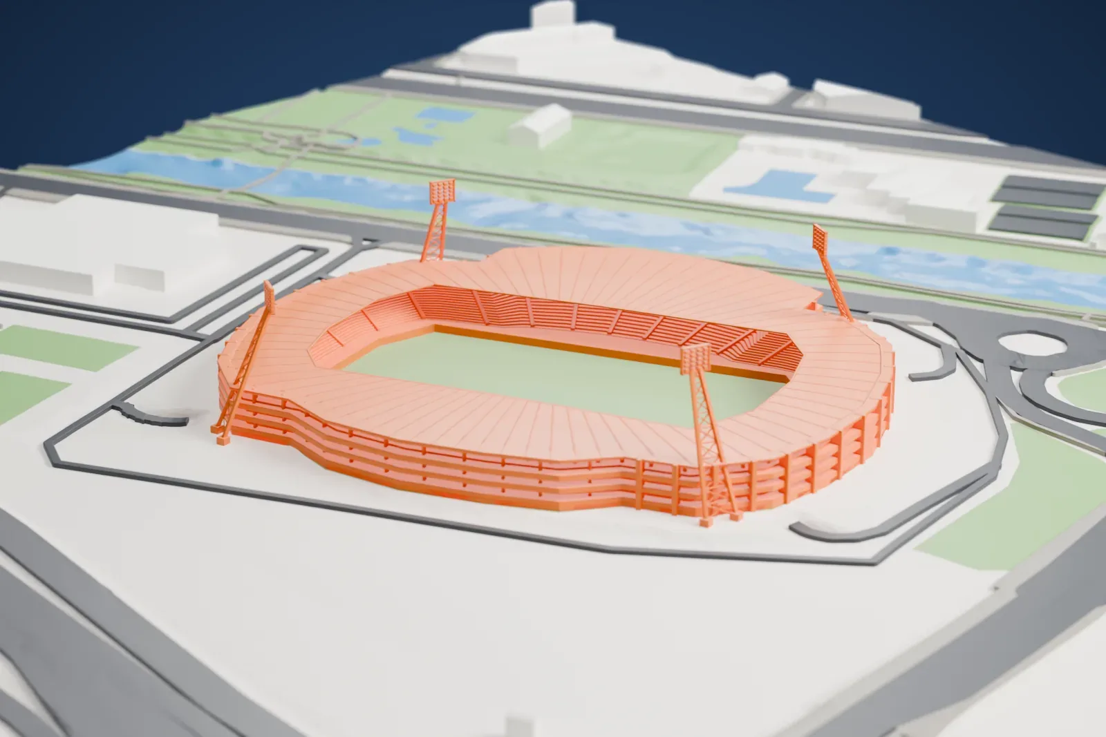 A white 3D print of Estadio Reino de León, an oval stadium with a ribbed roof and tall floodlight masts, among surrounding roads and buildings.