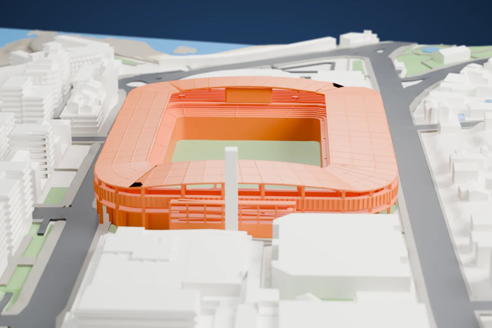 A white 3D print of the Estadio Riazor, a rectangular football bowl with four linked canopies around an open pitch, among surrounding streets and buildings.