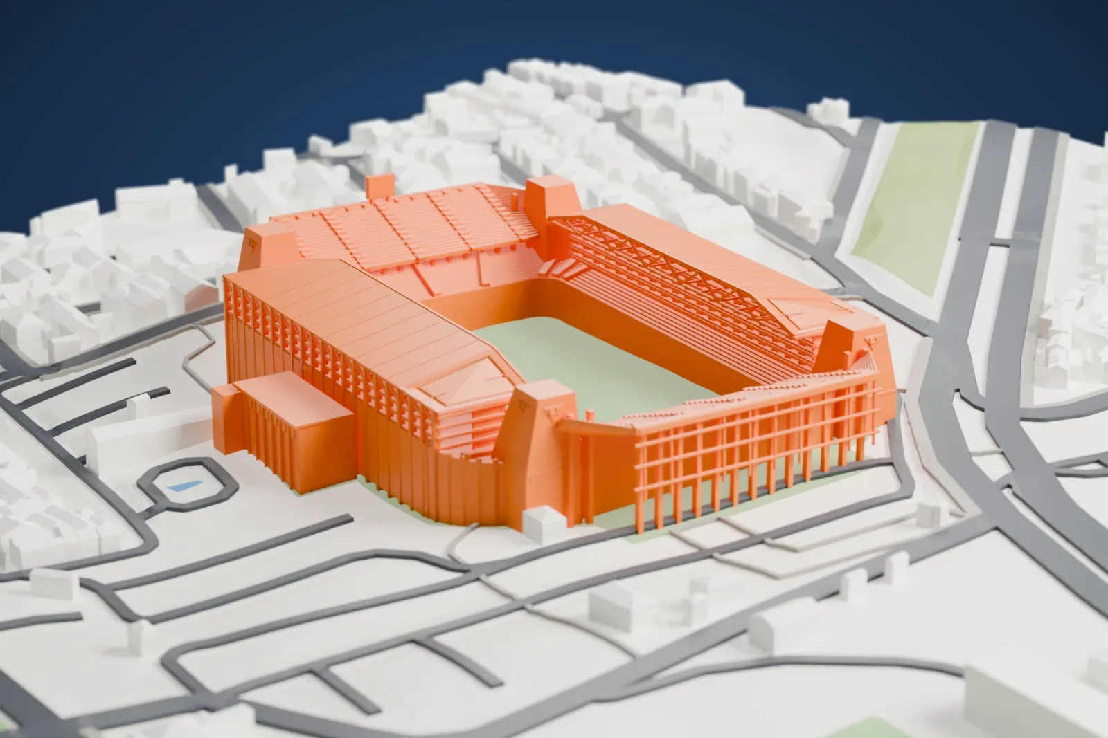 A white 3D print of Estadio Rodrigo Paz Delgado, an open football bowl with two separate side roofs and four tapered corner towers, among surrounding city buildings.