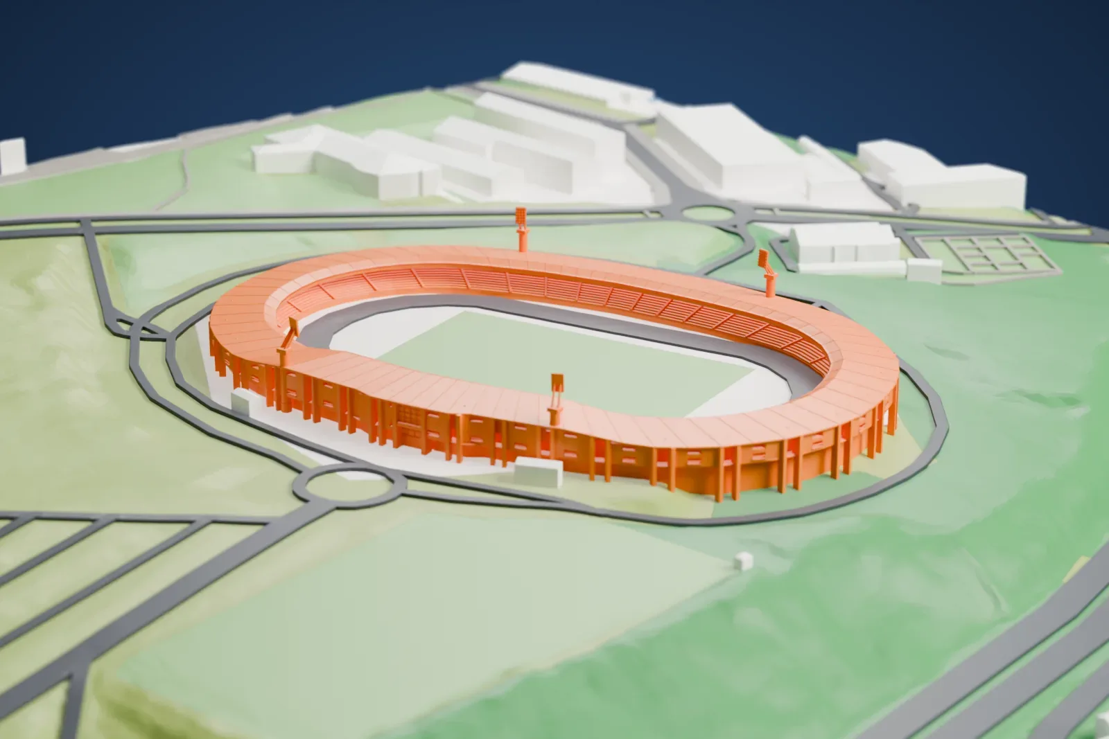 A white 3D print of Estadio Verónica Boquete de San Lázaro, an oval stadium with a ring roof around a pitch and running track, on rolling hills with roads and a few buildings nearby.