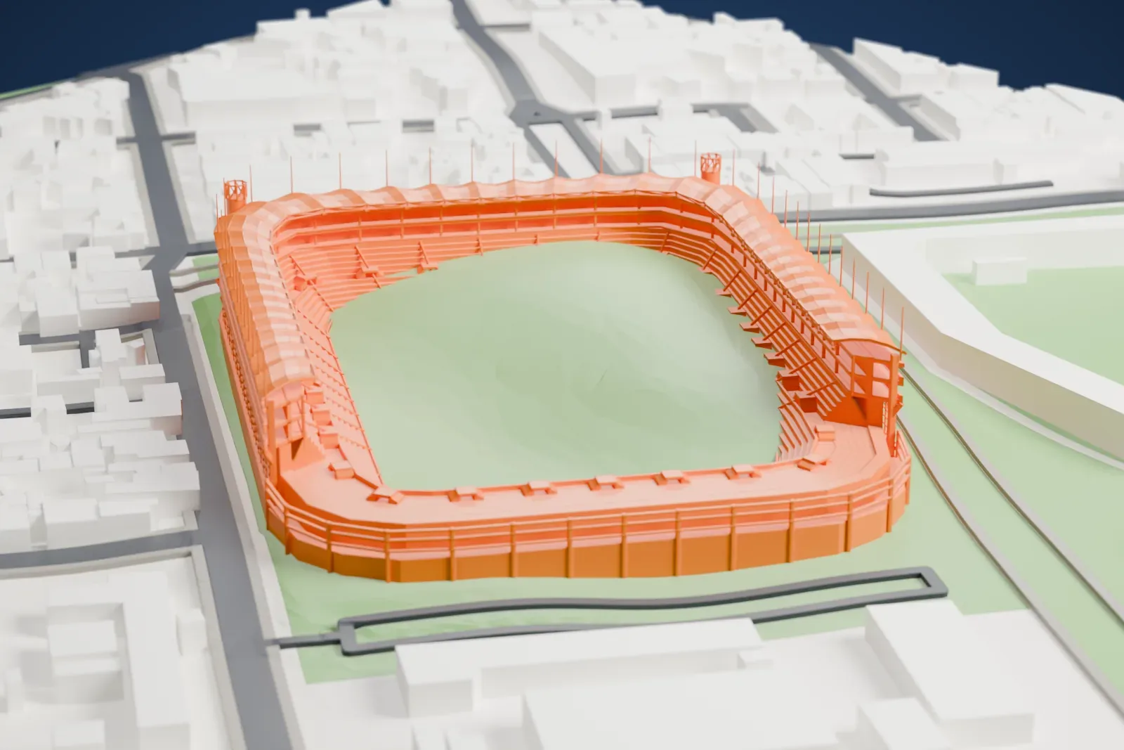 A white 3D print of Estadio Victoria, an open bowl with a three-sided scalloped canopy and twin ramp towers, among the streets and buildings of Aguascalientes.