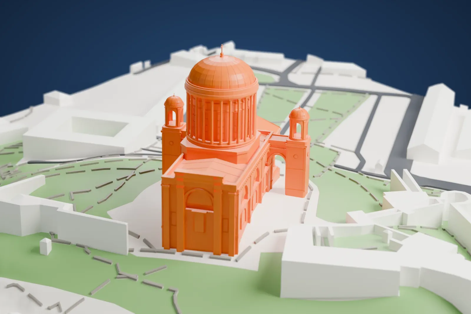 A white 3D print of the Esztergom Basilica, a domed church with a columned porch and two small domed turrets, standing on green ground crossed by paths, with buildings nearby.