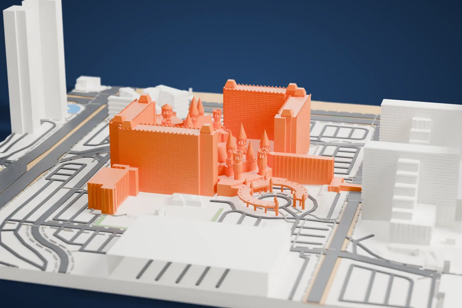 A white 3D print of Excalibur Hotel and Casino, with its pointed castle turrets in front of tall hotel towers, set among roads and low buildings.