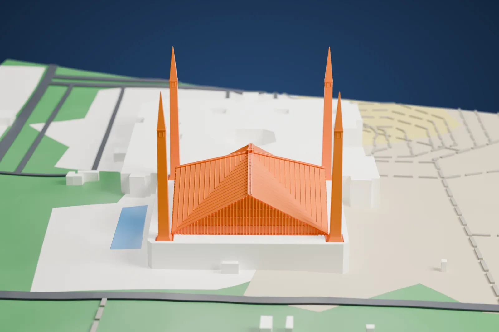 A white 3D print of Faisal Mosque, a tent-shaped mosque with a ribbed sloping roof and four tall slender minarets, standing on a wide platform with green slopes and open ground around it.