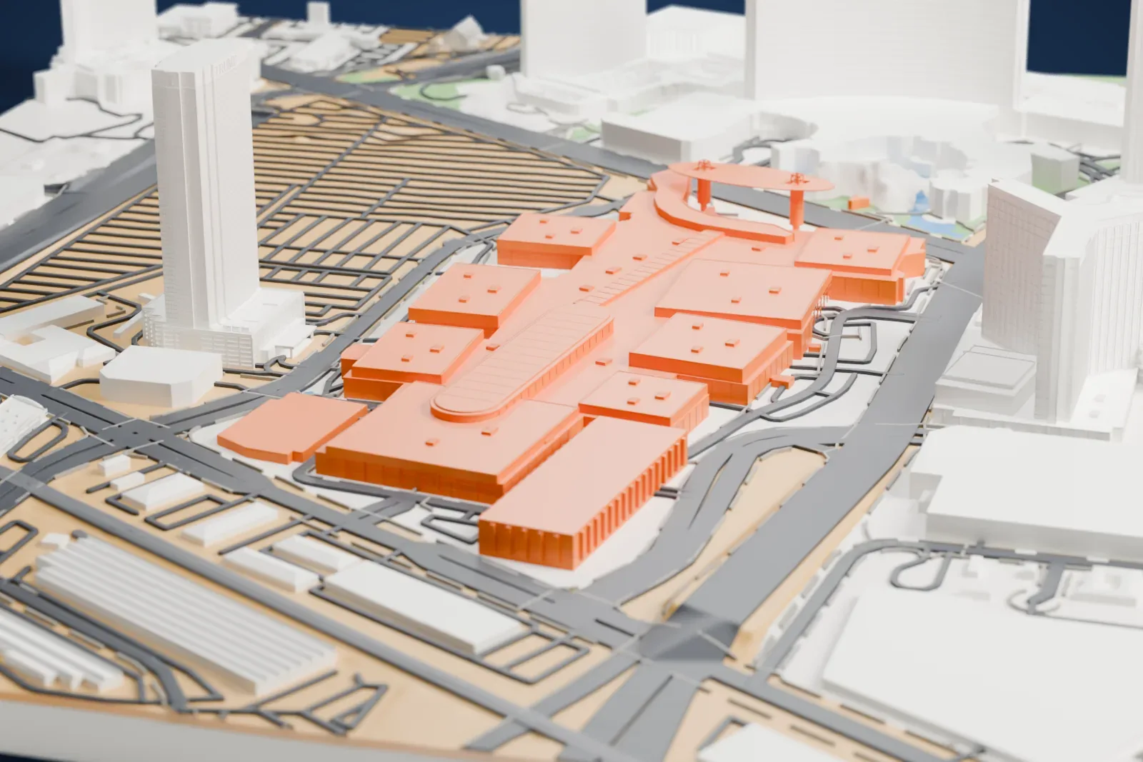 A white 3D print of Fashion Show Las Vegas, a large, low mall with flat roofs and an oval roof feature, beside wide roads and parking lots, with tall towers behind it.