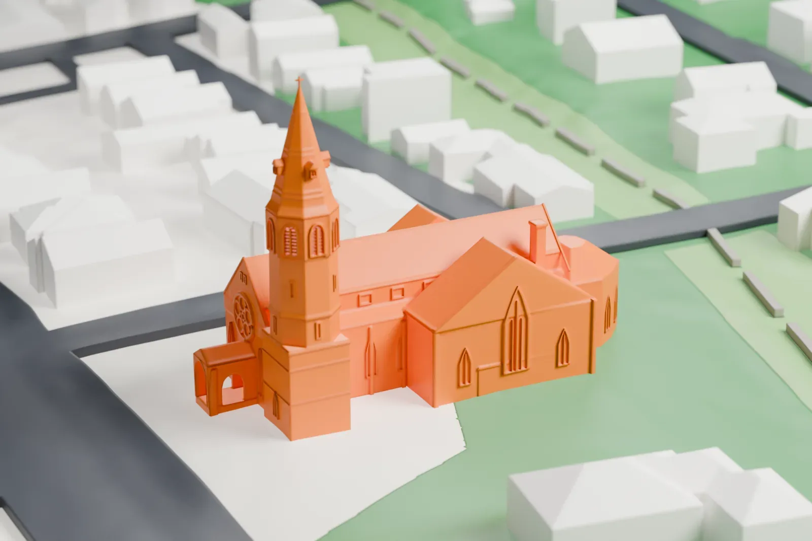 A white 3D print of the First Baptist Church of Tarrytown, a gabled church with a tall spired tower, standing among lawns, streets and small buildings.