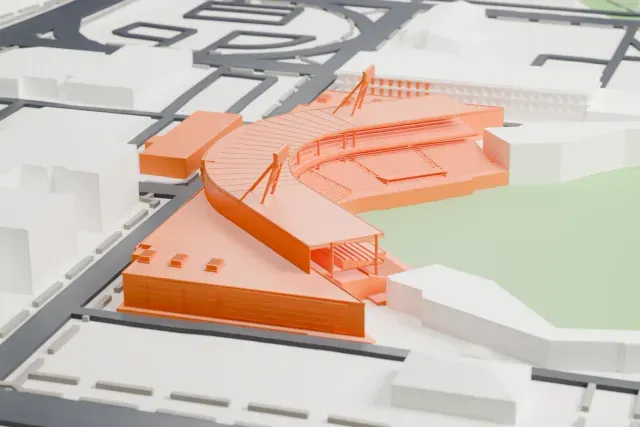 A white 3D print of First Horizon Park, a curved ballpark grandstand with two slim light towers wrapping a green field, among downtown blocks and streets.