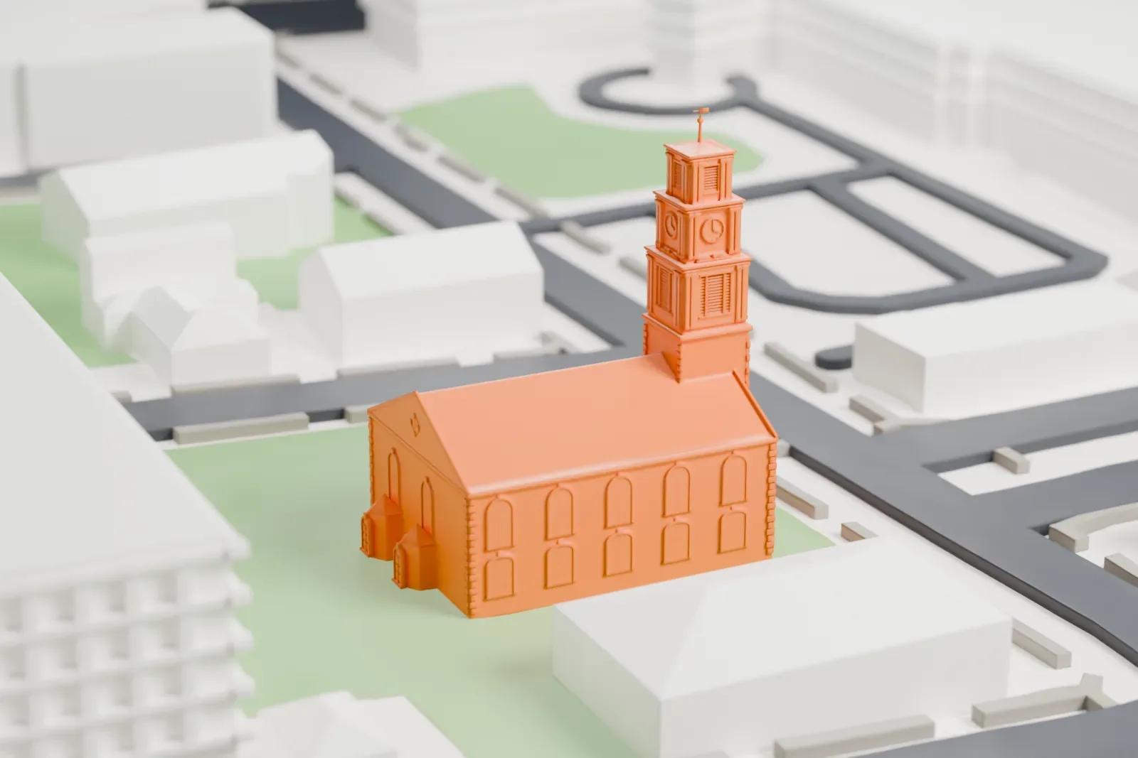 A white 3D print of the First Reformed Church of New Brunswick, a gabled church with a tall steeple, on a green lawn beside streets and larger buildings.