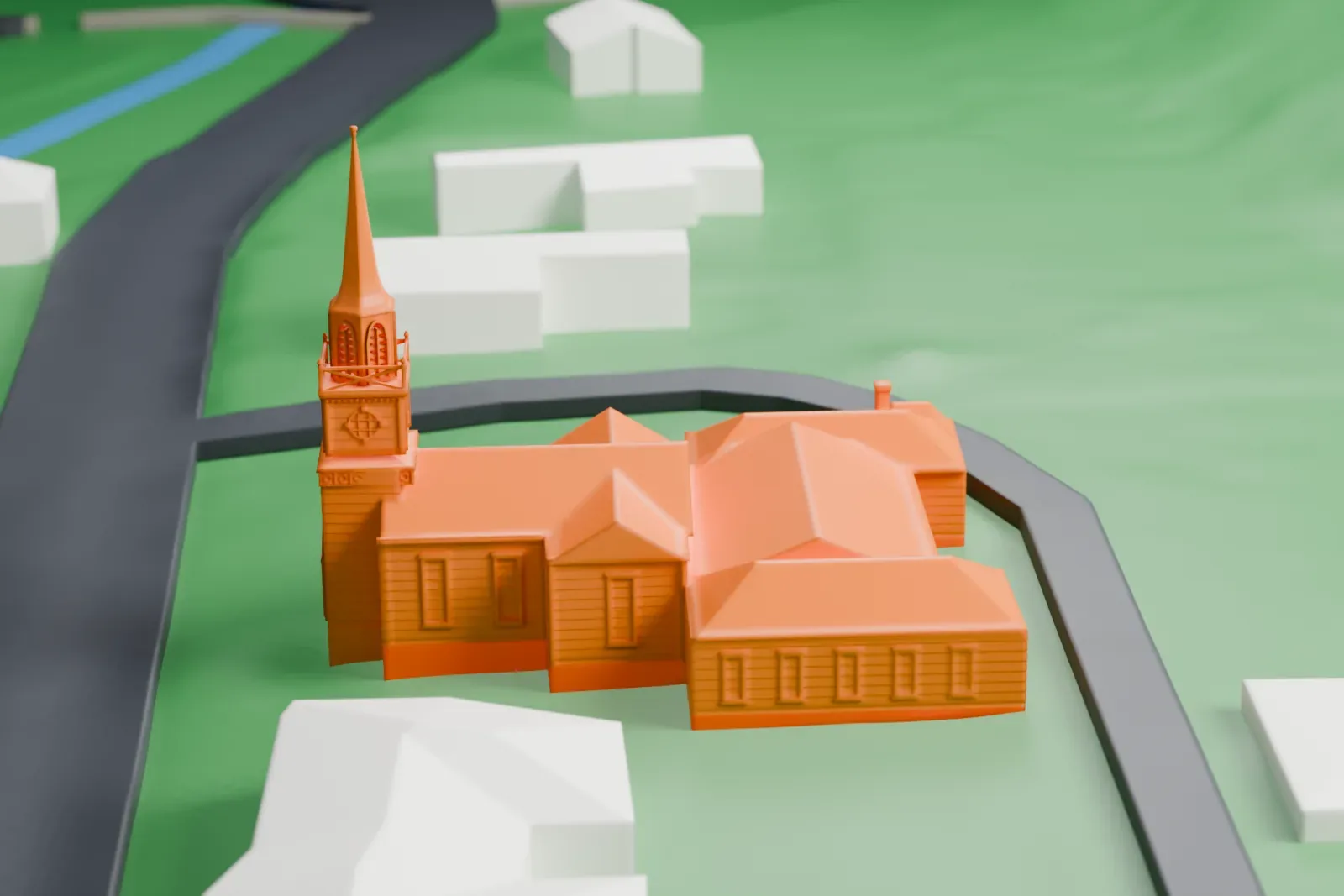 A white 3D print of First Reformed Church in Piermont, a church with a tall slender steeple and a long attached hall, on a green lawn beside a curving road and a stream.