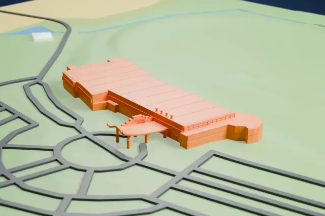 A white 3D print of the Flamboro Downs Grandstand model in Hamilton, with the streets around it.