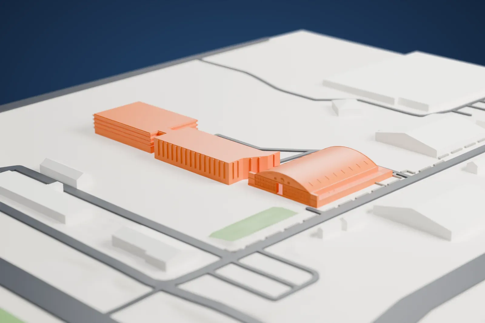 A white 3D print of the Flying Heritage & Combat Armor Museum hangars, a large arched-roof hangar with lettering on its end wall, among roads and low gray buildings.