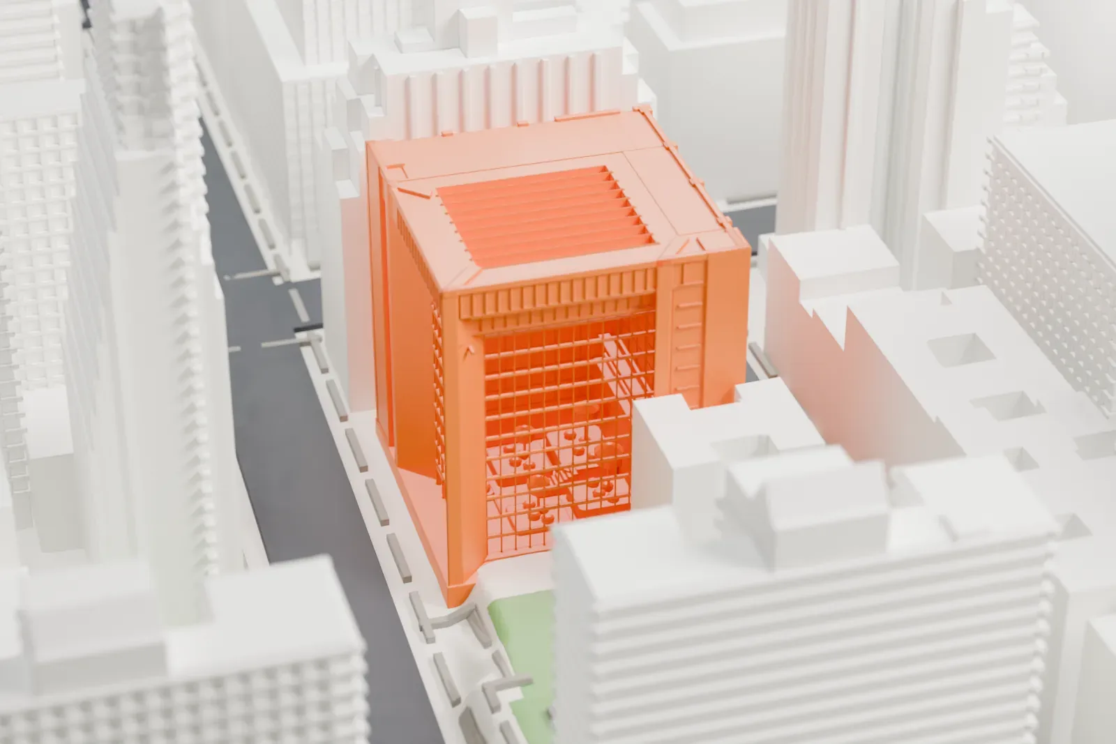 A white 3D print of the Ford Foundation Center for Social Justice, a boxy cube with an open glass front and a ribbed roof, tucked among taller buildings.
