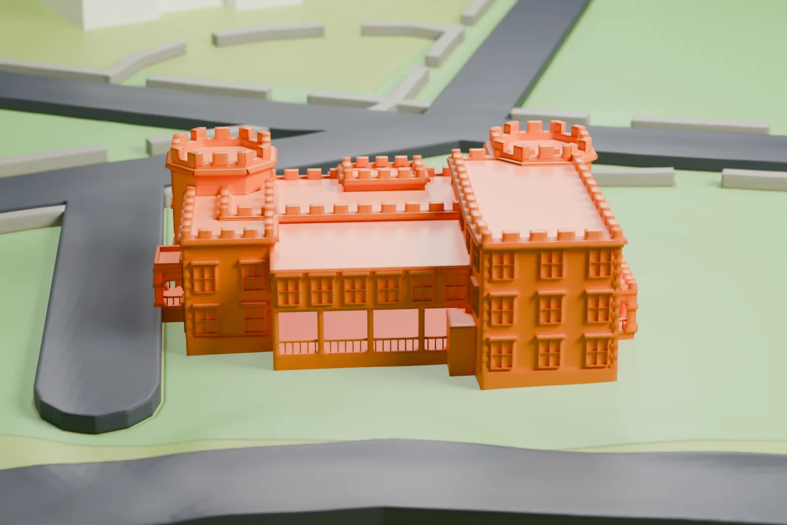 A white 3D print of the Fort Totten Officers' Club, a castle-like building with crenellated towers, porches and rows of windows, on a green lawn beside roads.