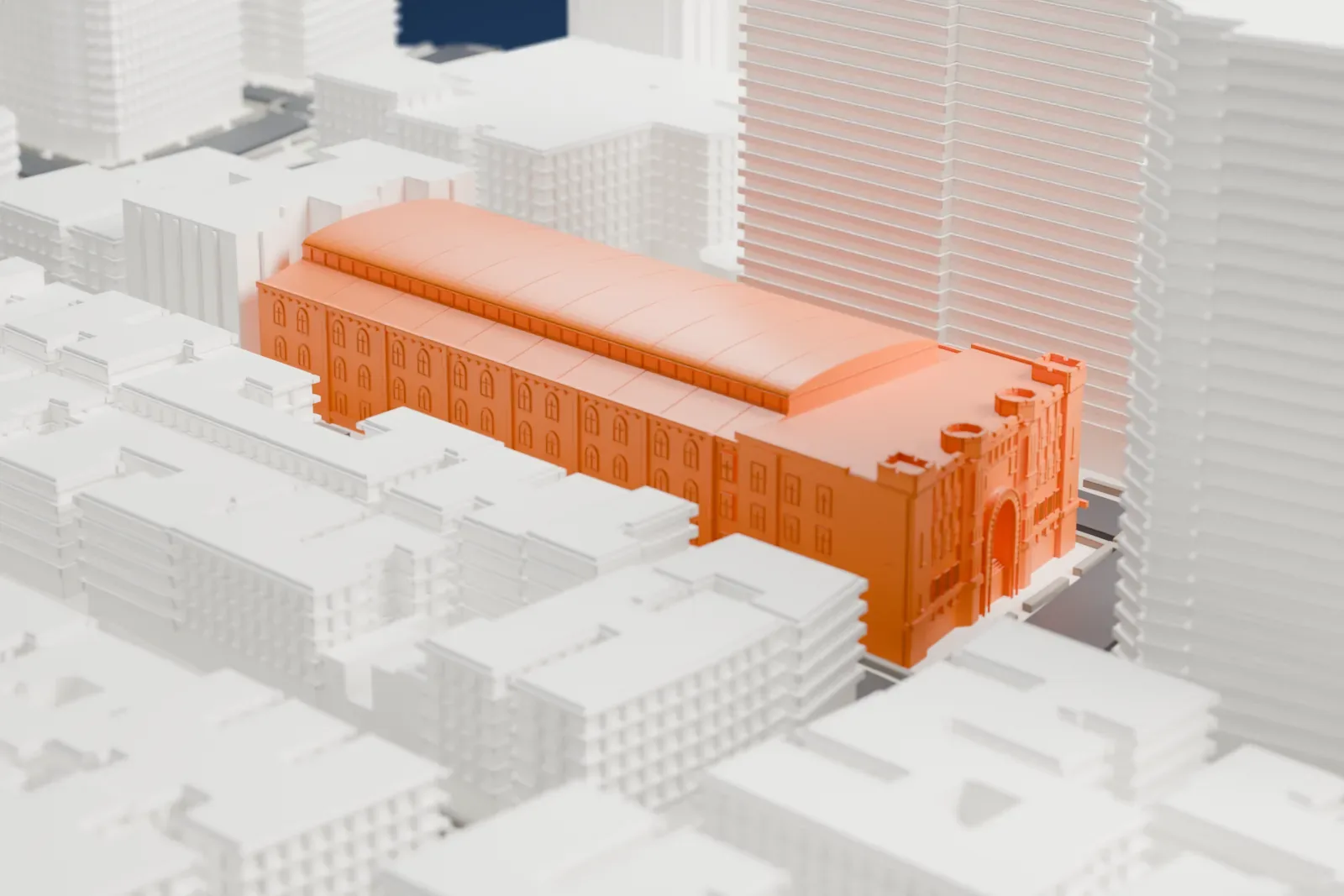A white 3D print of the Fort Washington Avenue Armory, a long hall with a curved roof, set among mid-rise buildings and taller towers.