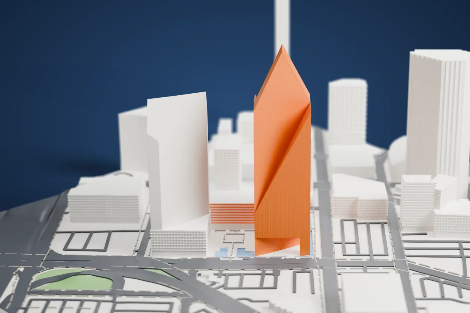 A white 3D print of Fountain Place, a faceted tower with sloping sides and a pointed top, standing among other buildings and streets.