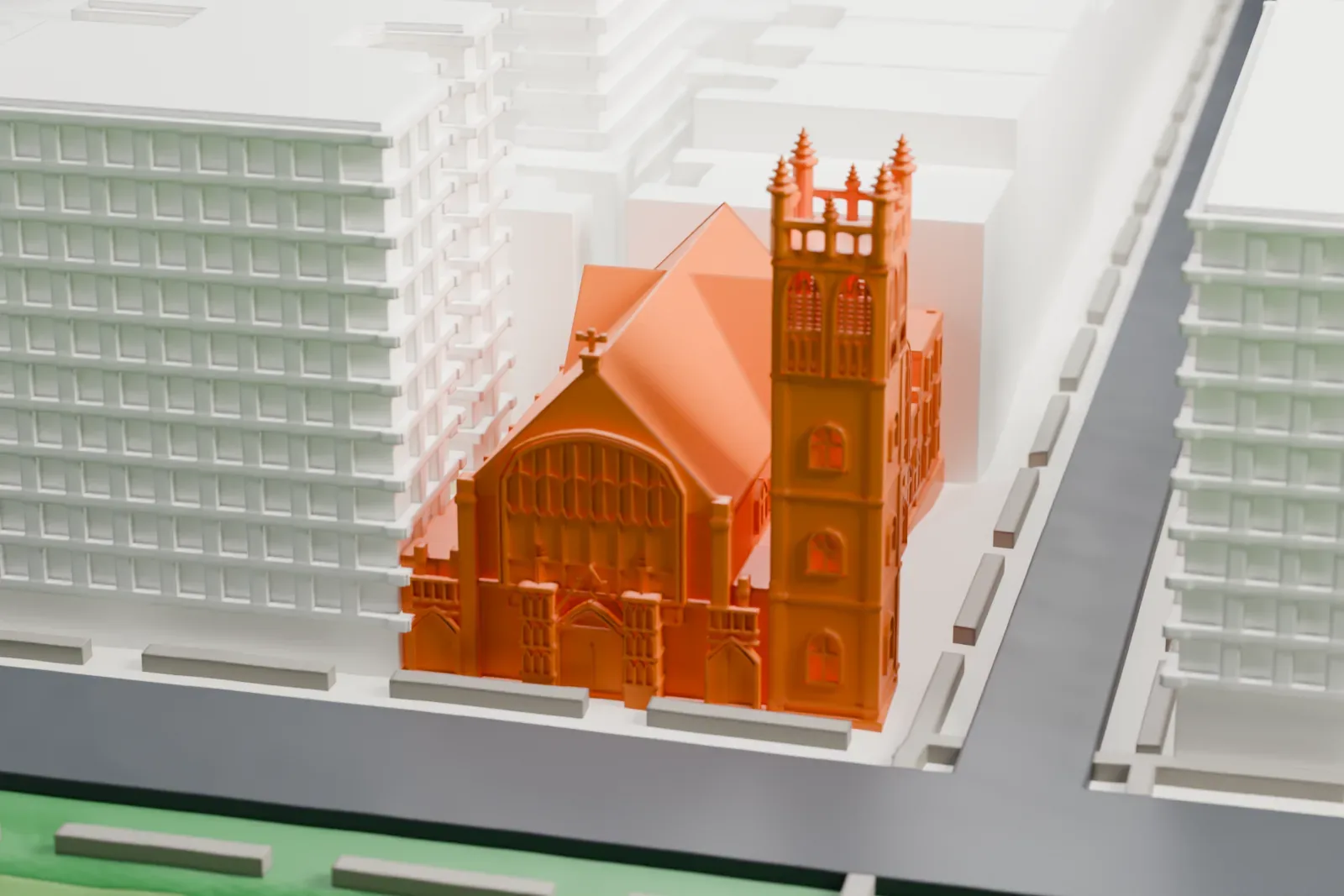 A white 3D print of the Fourth Universalist Society church, a Gothic-style corner building with a tall pinnacled tower, beside a park and mid-rise buildings.