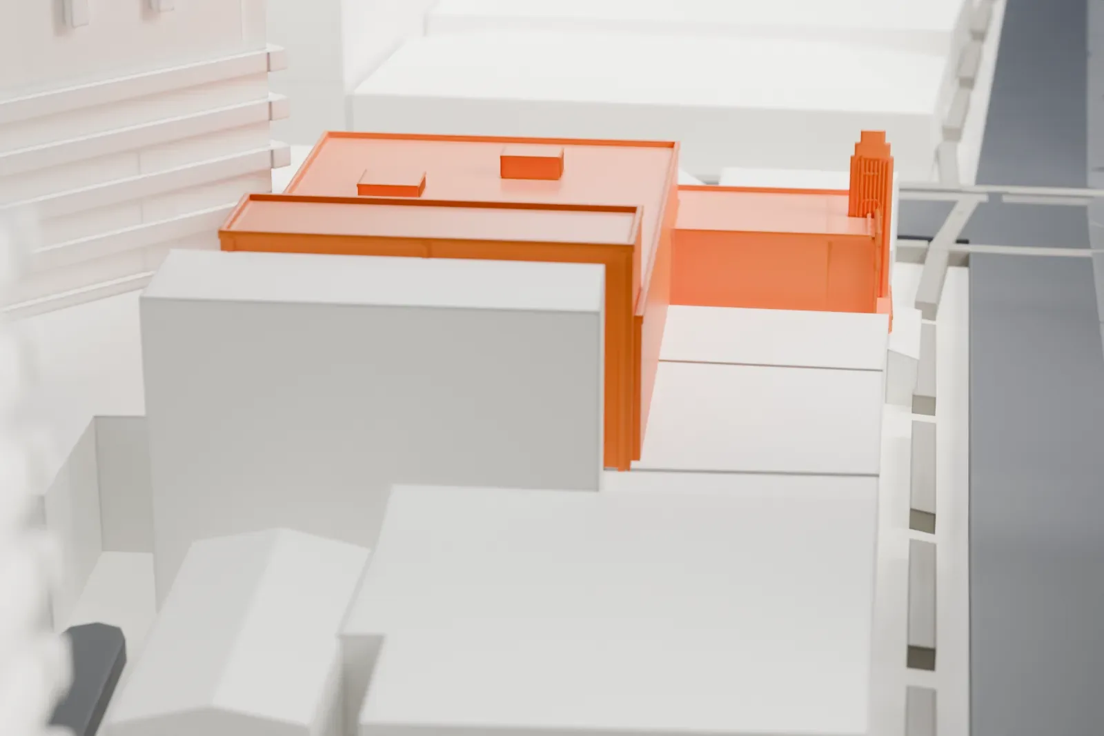 A white 3D print of the Fox Tucson Theatre with its flat roof and narrow raised facade, surrounded by streets and buildings, including a taller neighboring building.