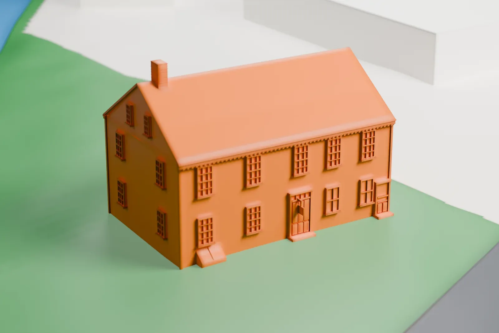 A white 3D print of the Franklin Inn, a two-story gabled house with chimneys and a small side wing, on a green lot beside a road and a band of water.
