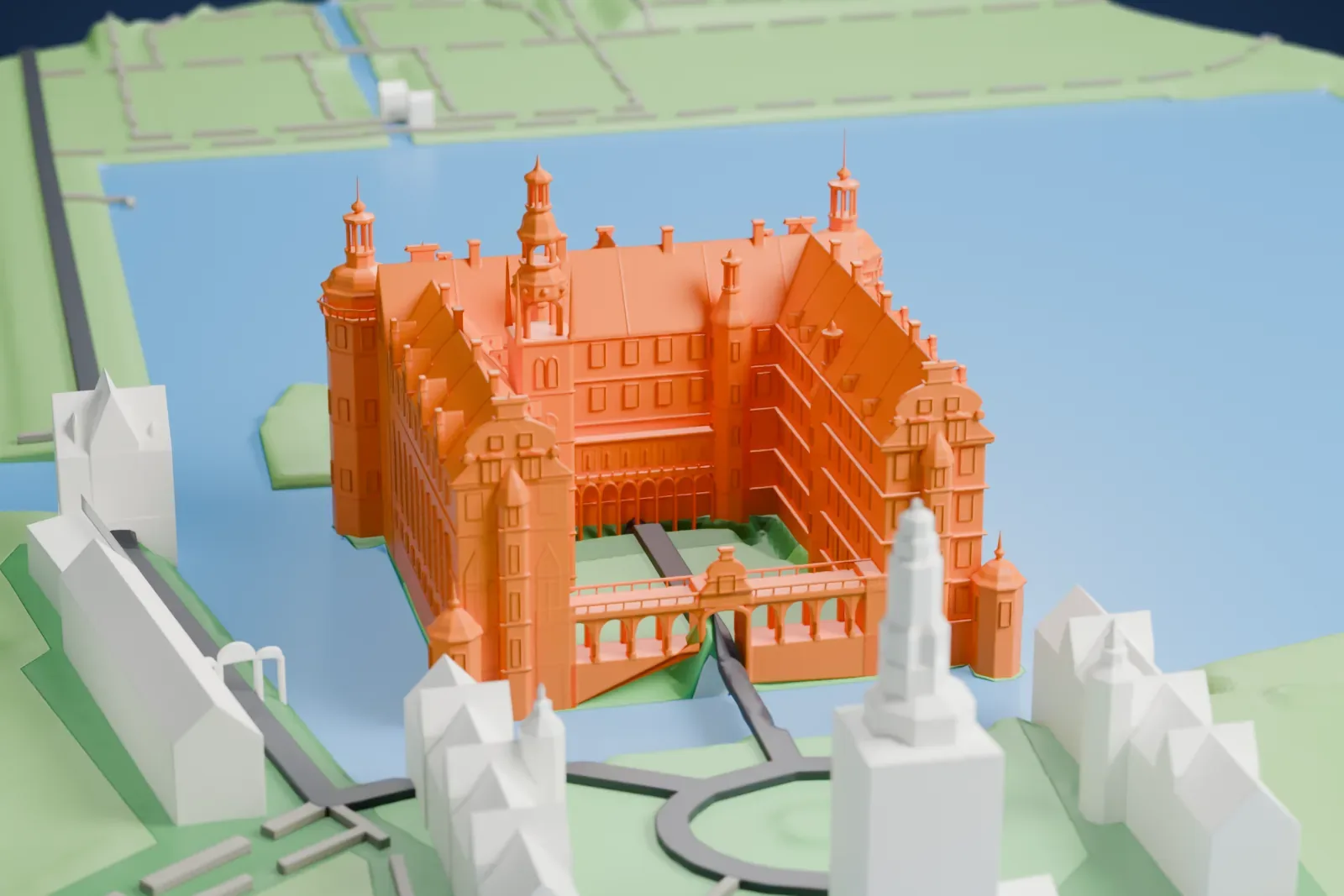 A white 3D print of Frederiksborg Castle, a castle with stepped gables, round corner towers and a tall spired tower, standing on islets in a lake with small buildings nearby.