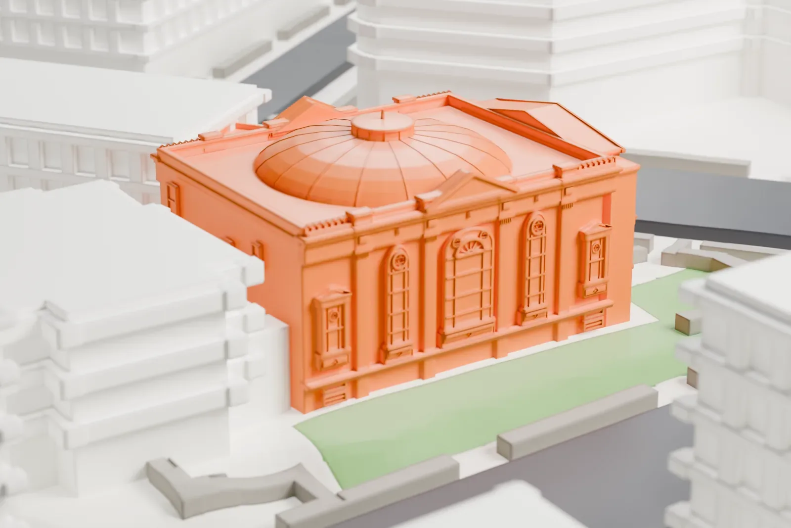 A white 3D print of the Free Synagogue of Flushing, a domed building with a columned front on a street corner, beside a small green lawn and taller buildings.