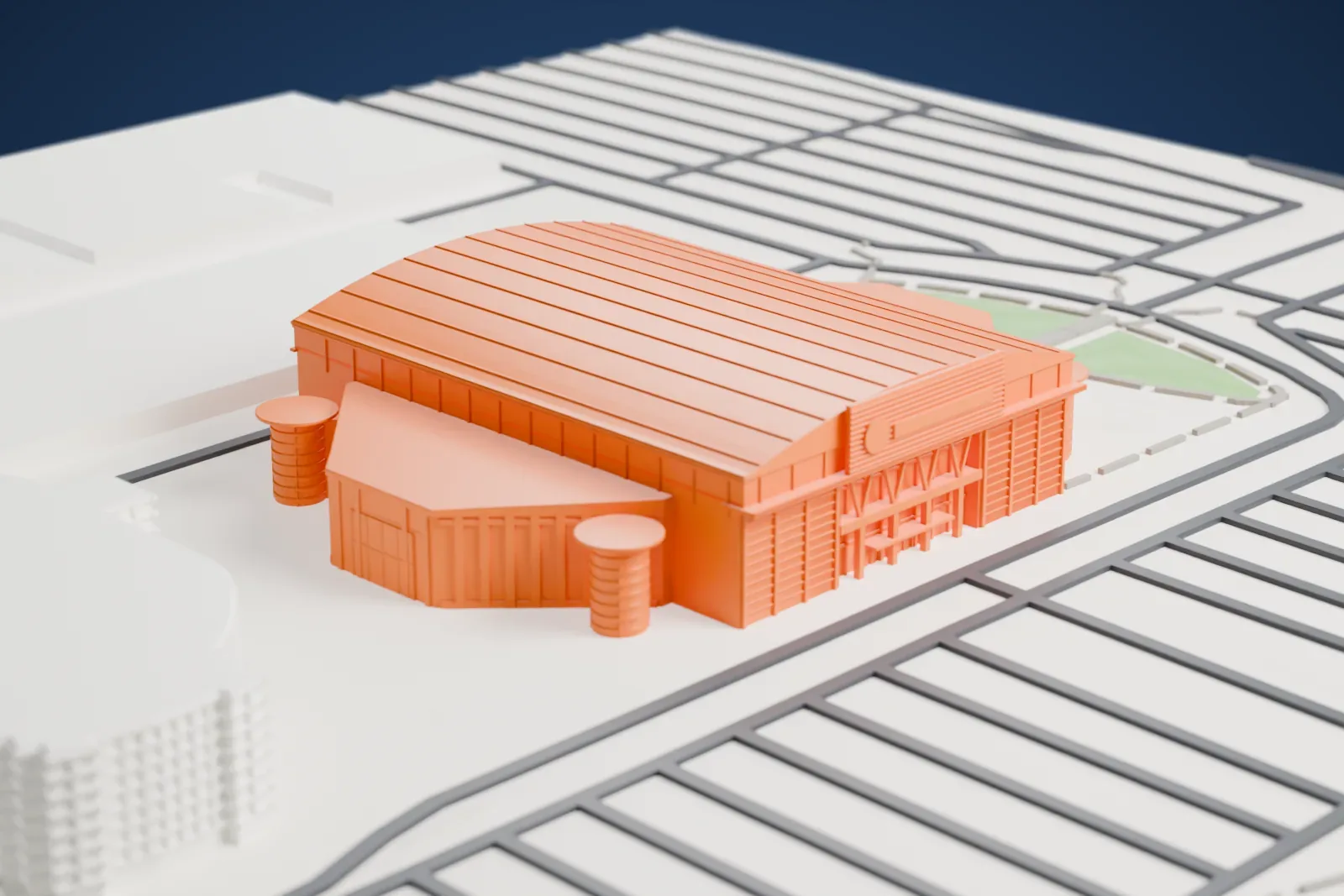 A white 3D print of Frost Bank Center, an arena with an arched vault, a slatted sign box and four round silos at its corners, among surrounding streets and buildings.