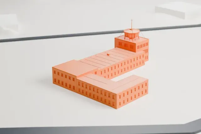 A white 3D print of the Fuerstenfeldbruck Air Base control tower model in Munich, with the streets around it.