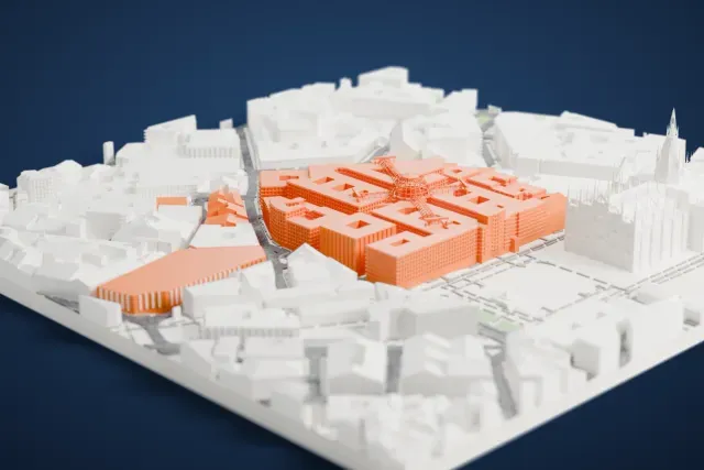 A white 3D print of the Galleria Vittorio Emanuele II, a cross-shaped ribbed roof with a central dome, set among dense city blocks beside a building with many spires.