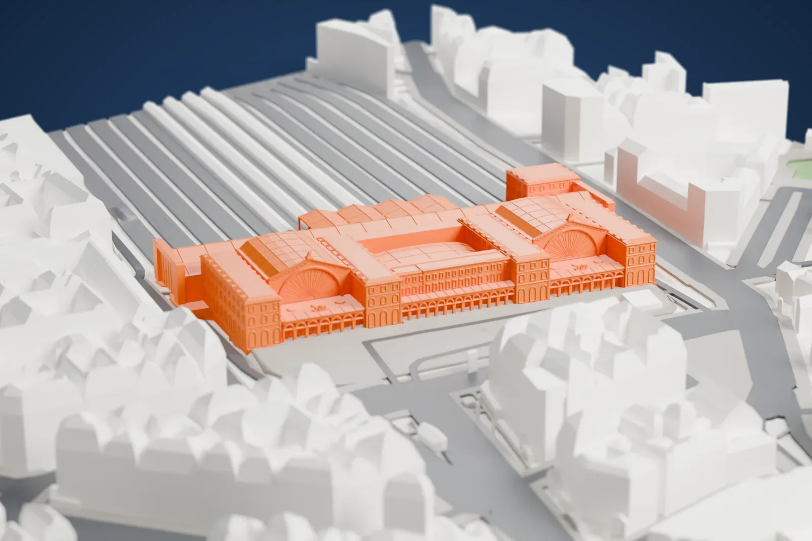 A white 3D print of the Gare de l'Est among the surrounding streets and buildings of Paris.