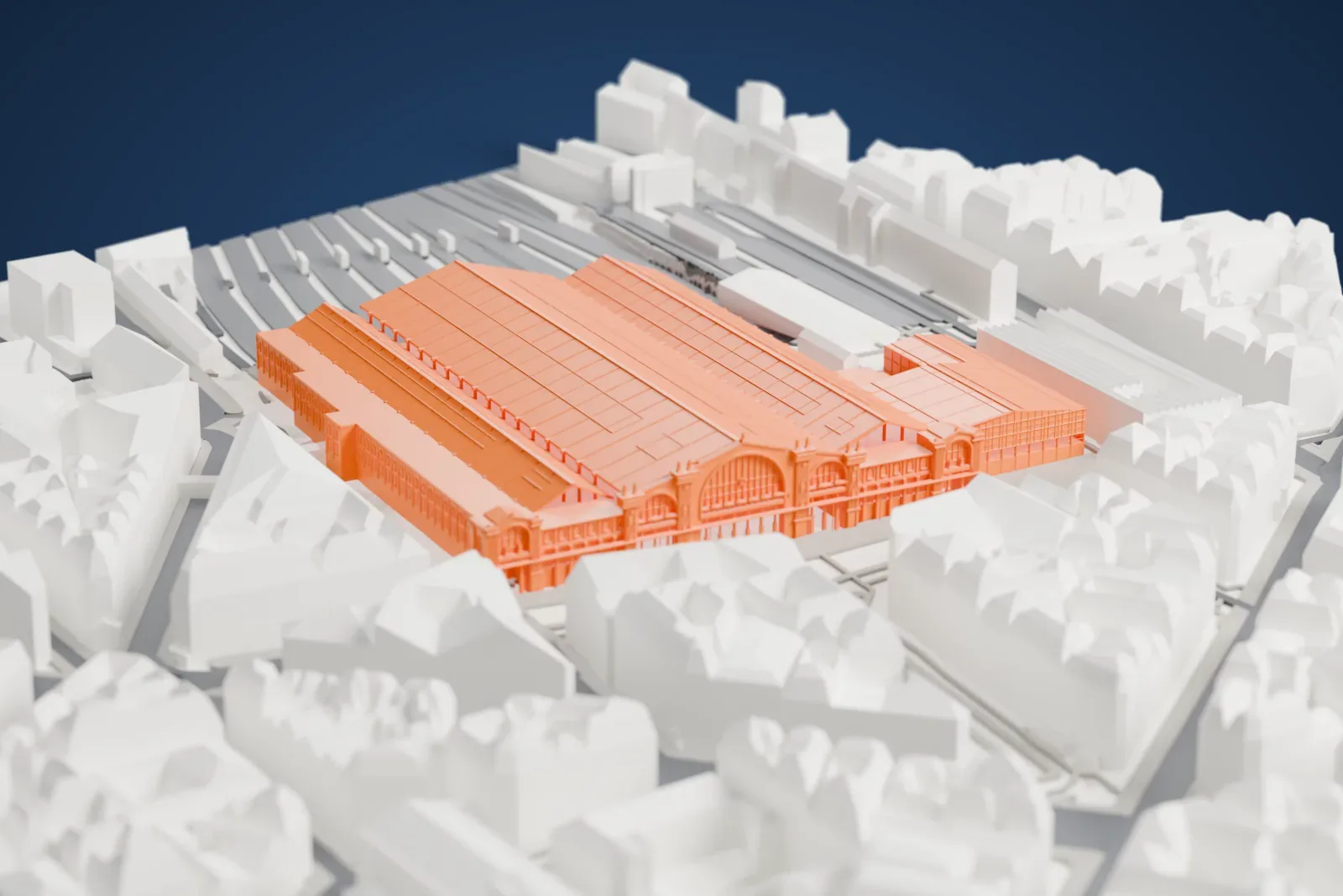 A white 3D print of the Gare du Nord, a station front with a triumphal arch and a long train shed behind it, among the streets of Paris.