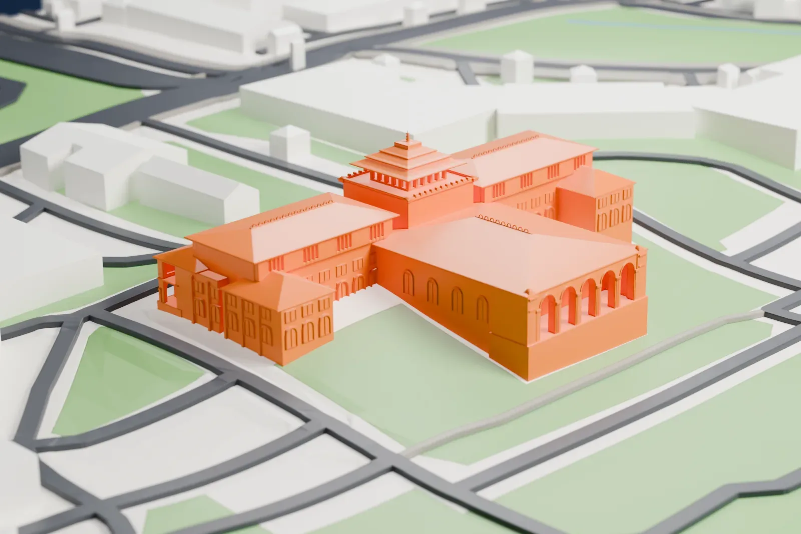 A white 3D print of Gedung Sate, a symmetrical building with a stepped central tower and long wings with arched ground floors, surrounded by streets, green areas and other buildings.