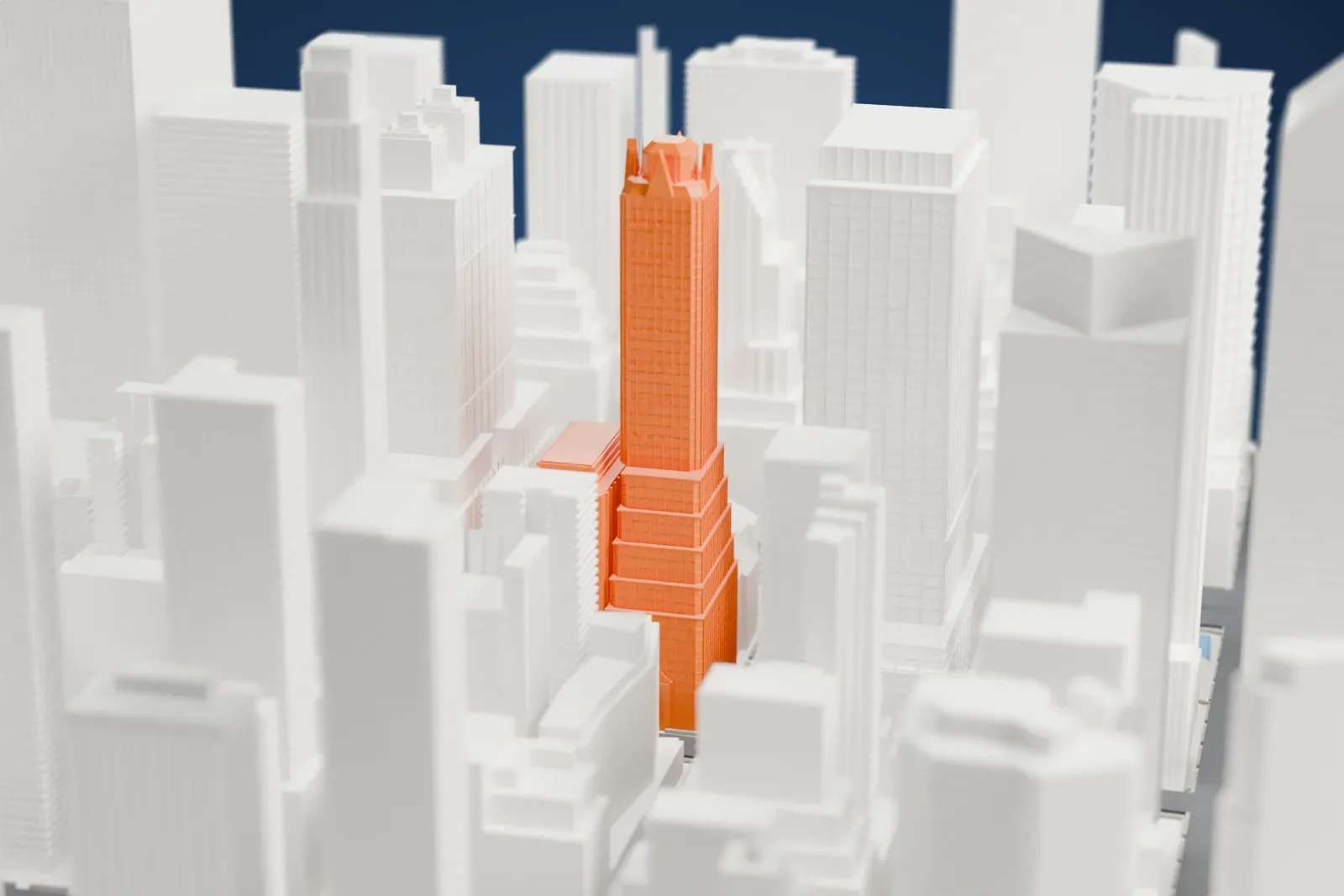 A white 3D print of the General Electric Building, a slender tower with a pointed Gothic crown rising among tall neighboring buildings.