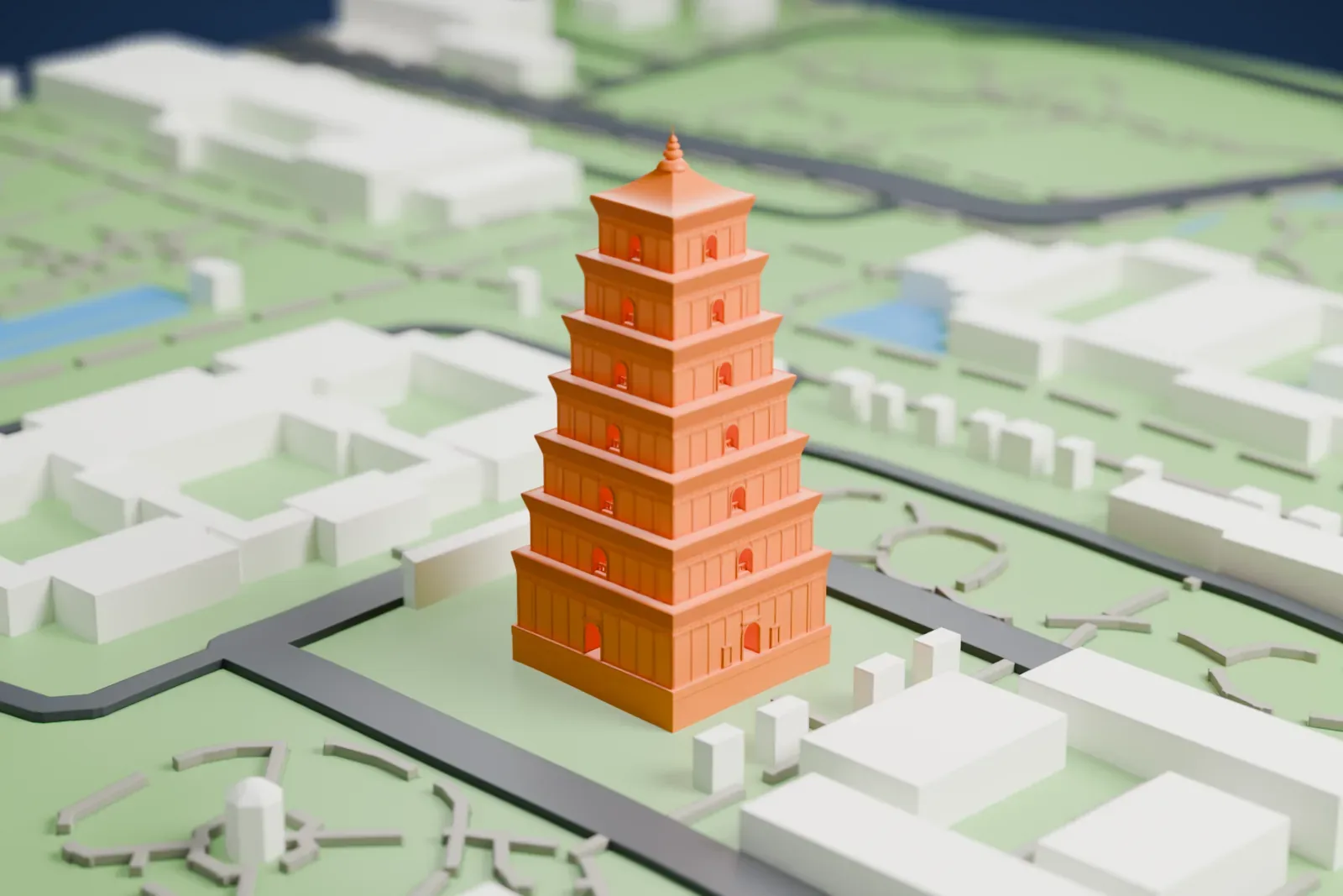 A white 3D print of the Giant Wild Goose Pagoda, a square tower of seven tapering tiers with arched openings and a pointed top, standing in green grounds with roads and low buildings nearby.