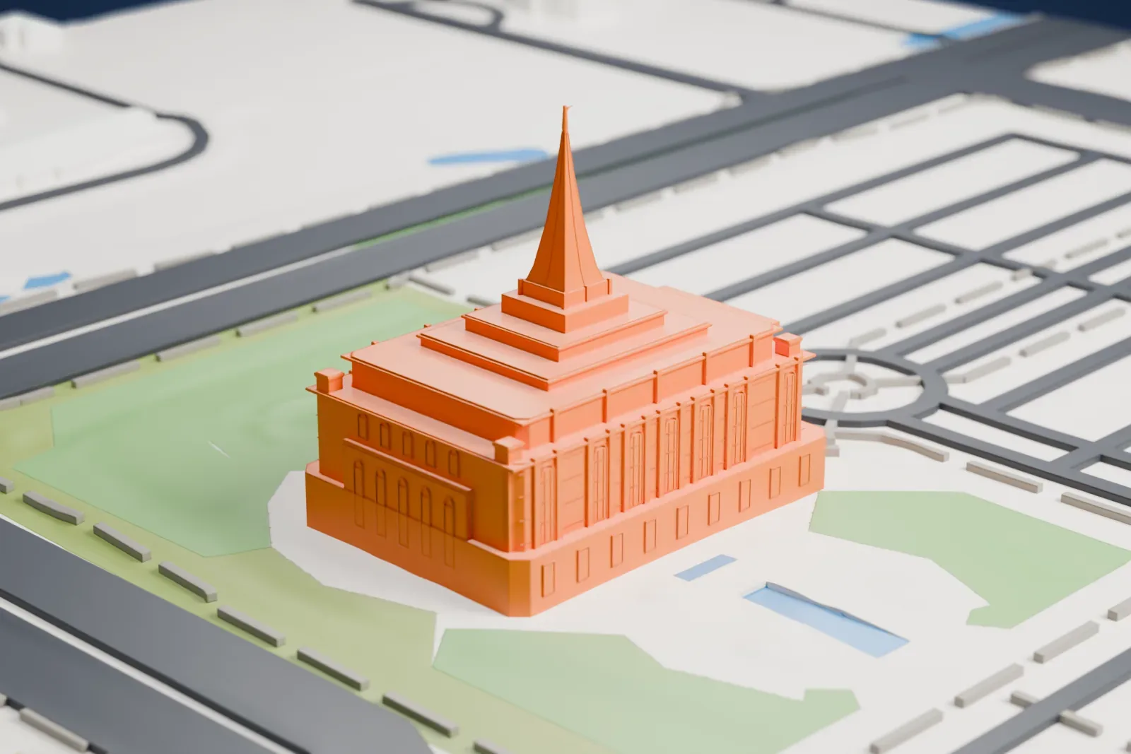 A white 3D print of the Gilbert Arizona Temple, a stepped building with a tall central spire, set on lawns beside small patches of water and roads.