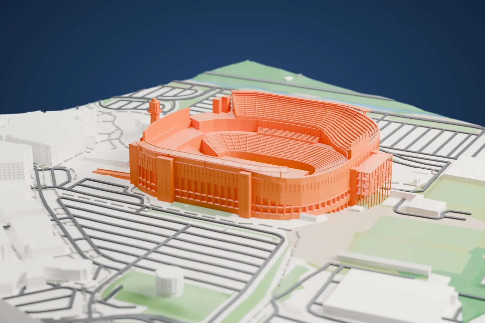 A white 3D print of Gillette Stadium, a tall-sided bowl with a thin canopy over its long stands and a lighthouse at one open end, among surrounding streets and buildings.