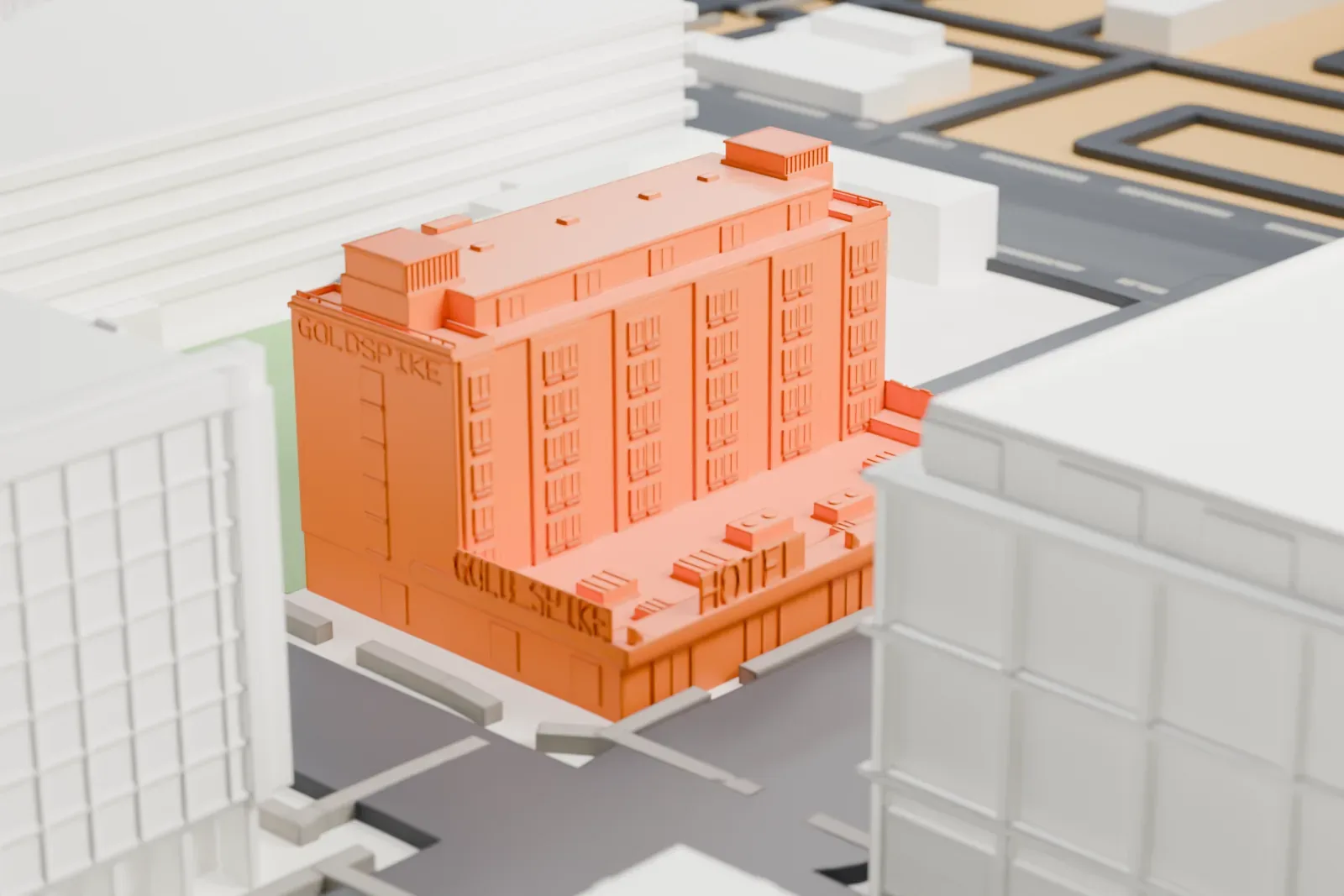 A white 3D print of Gold Spike, a seven-floor building with a grid of windows, raised lettering and a low podium, standing among larger buildings and a green lot.