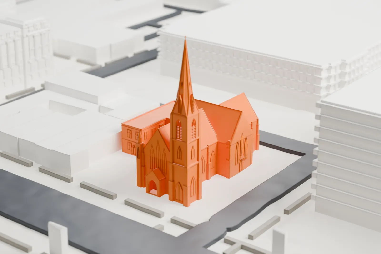 A white 3D print of Grace Church in Newark, a church with steep roofs and a tall slender spire, beside streets and larger buildings.