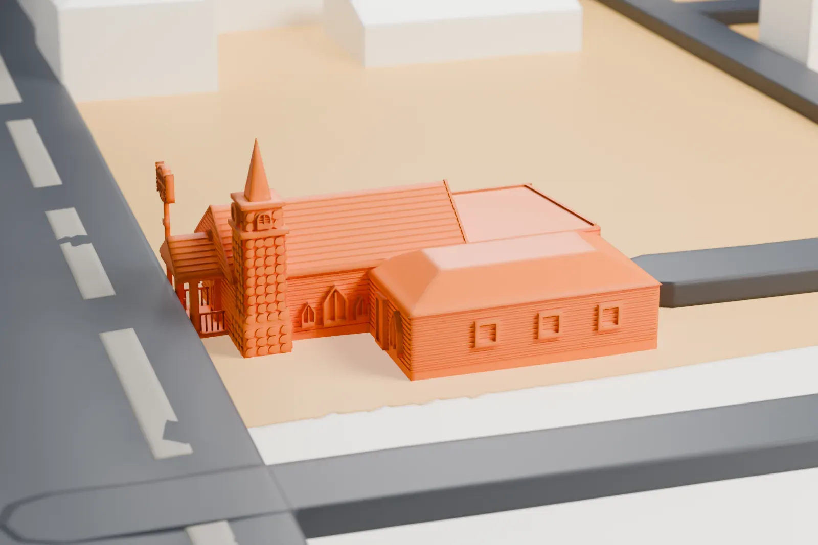 A white 3D print of the Graceland Wedding Chapel, a small gabled chapel with a pointed tower and a sign on a pole, on a lot beside wide streets.