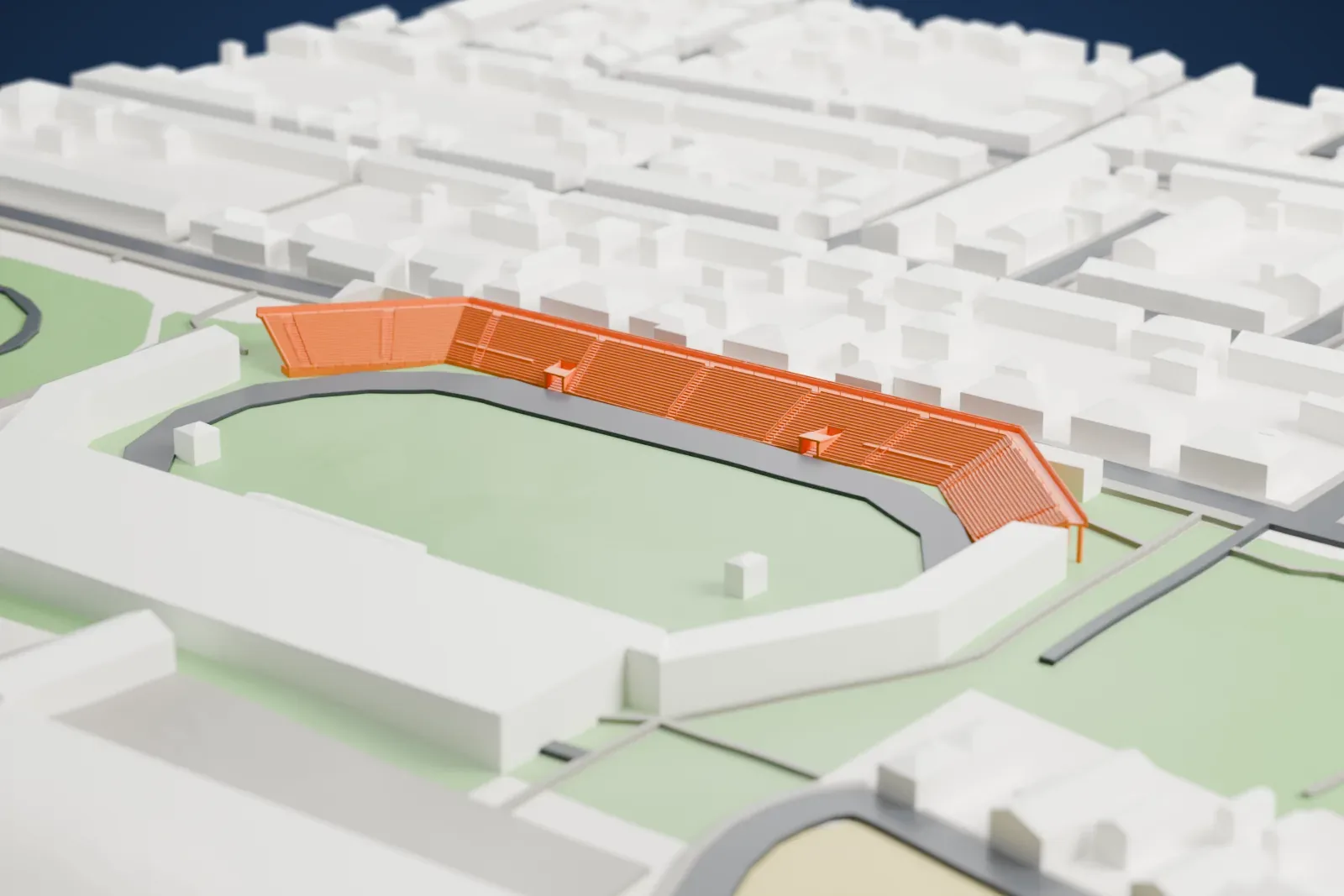 A white 3D print of Gradski vrt Stadium, an angled grandstand on slender columns beside a pitch and running track, with houses along the street next to it.