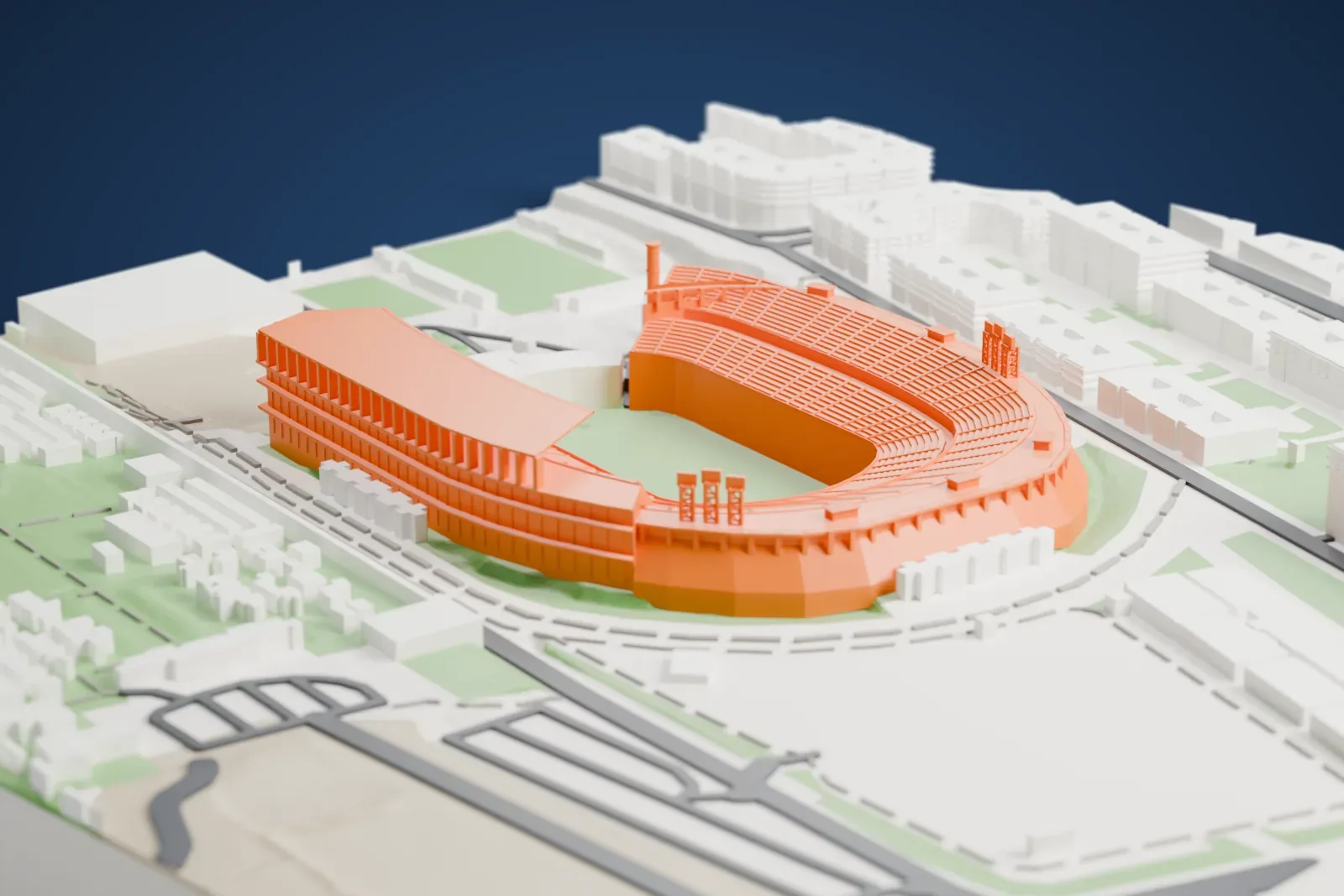 A white 3D print of Gran Canaria Stadium, an open bowl with a flat roof over one stand and two round cylinders at its open end, among surrounding streets and buildings.