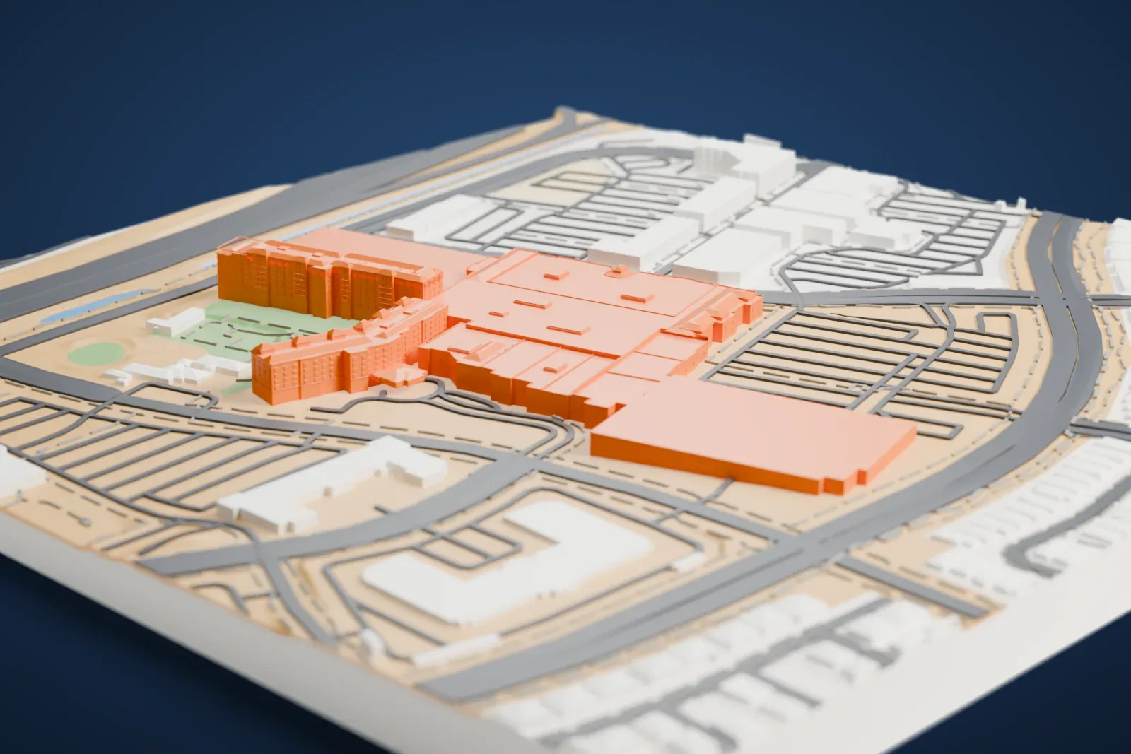 A white 3D print of Green Valley Ranch, a long, low hotel and casino complex with a hotel wing, surrounded by curving roads, parking lots and landscaped grounds.