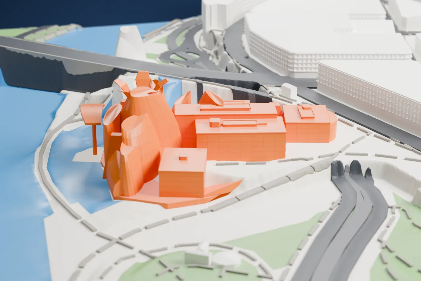 A white 3D print of the Guggenheim Museum Bilbao, a cluster of swirling curved forms beside a river with a bridge passing close by, among long curved buildings and green spaces.