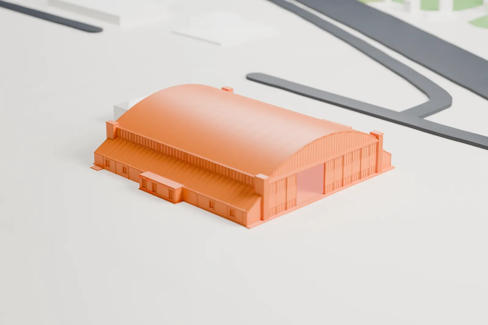 A white 3D print of the Gulfport Army Air Field Hangar, a long hangar with a curved vaulted roof and low lean-to sides, on open airfield ground beside roads.