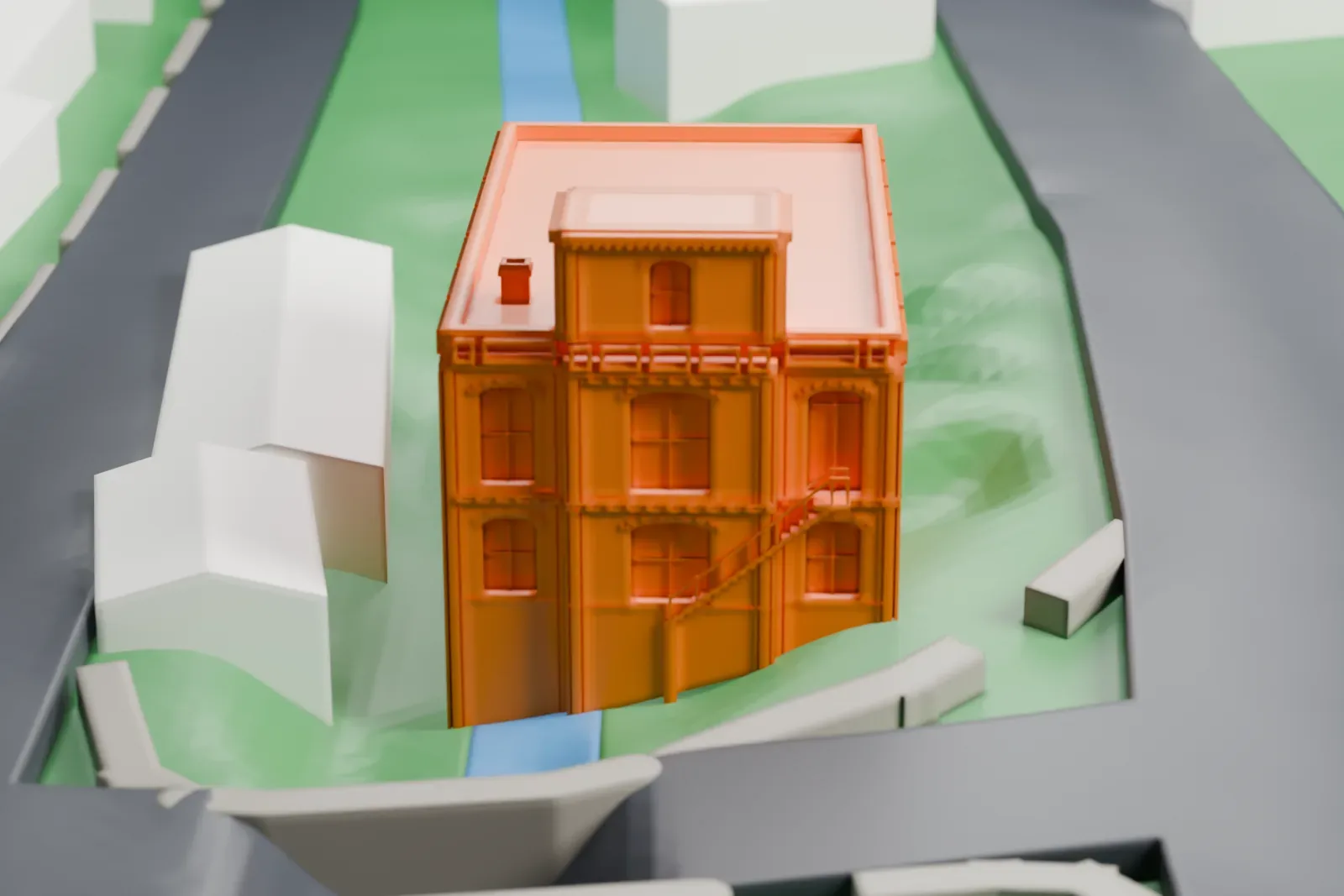 A white 3D print of Haddock's Hall, a building with a small tower on its roof, standing among lawns with streets, a little water and a few larger buildings nearby.
