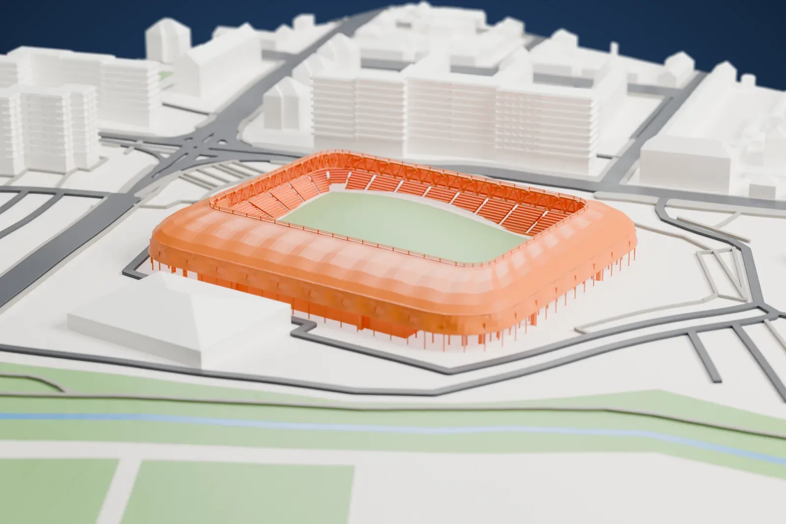 A white 3D print of Haladás Sportkomplexum, a football stadium with rounded corners and a ribbed roof around a green pitch, among surrounding streets and buildings.