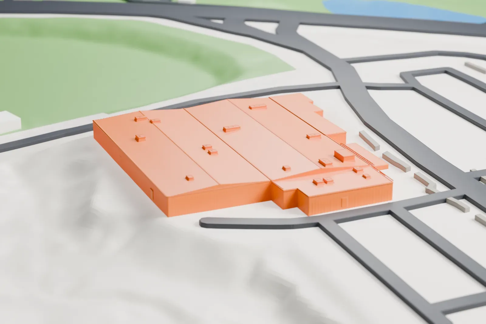 A white 3D print of the Hall of Flame Fire Museum, a long, low building with ribbed walls and a roof dotted with small boxes, beside curving roads and a green park.