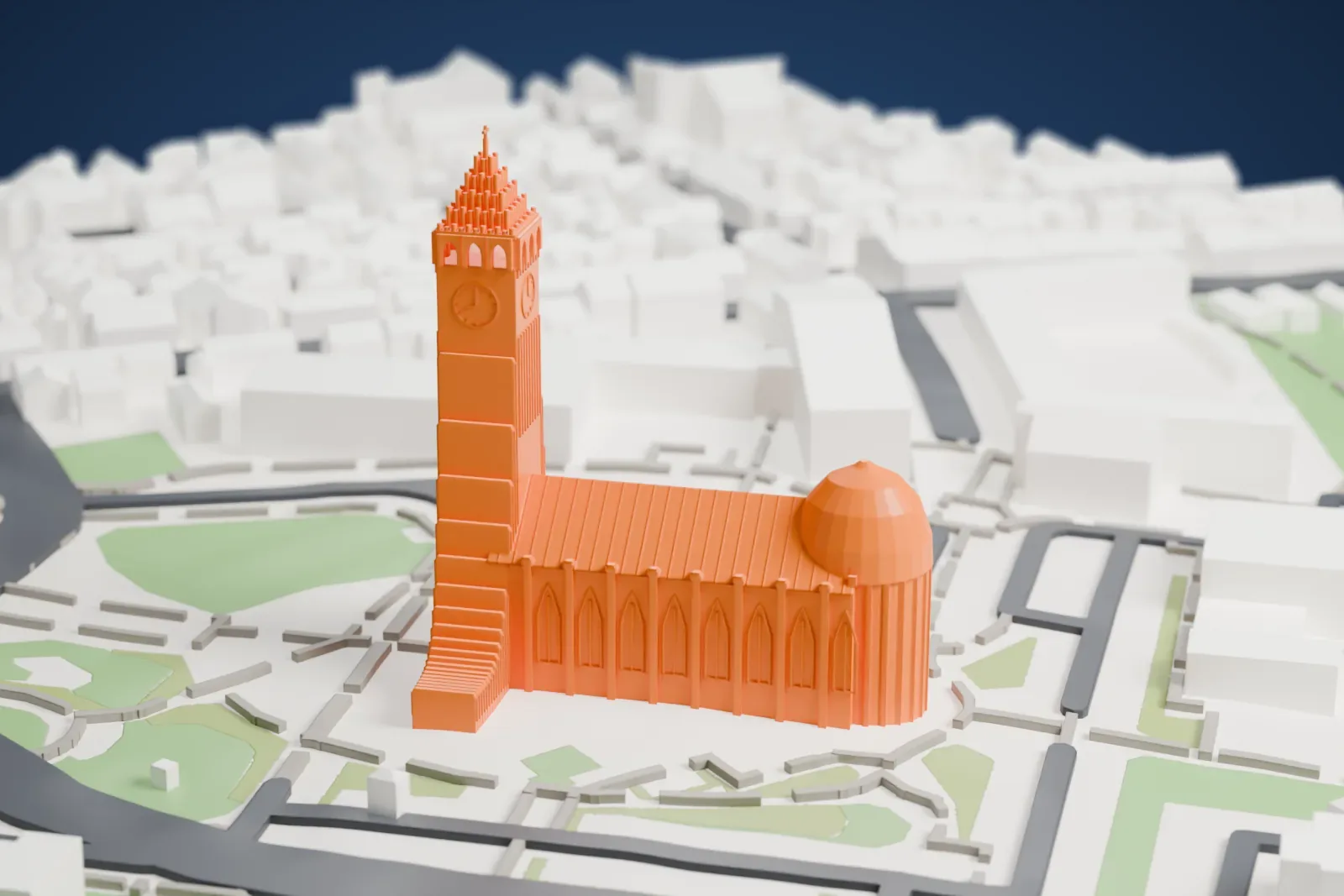 A white 3D print of Hallgrímskirkja, a tall tower with a stepped crown and curved side wings joined to a long ribbed nave, surrounded by streets, green patches and small buildings.