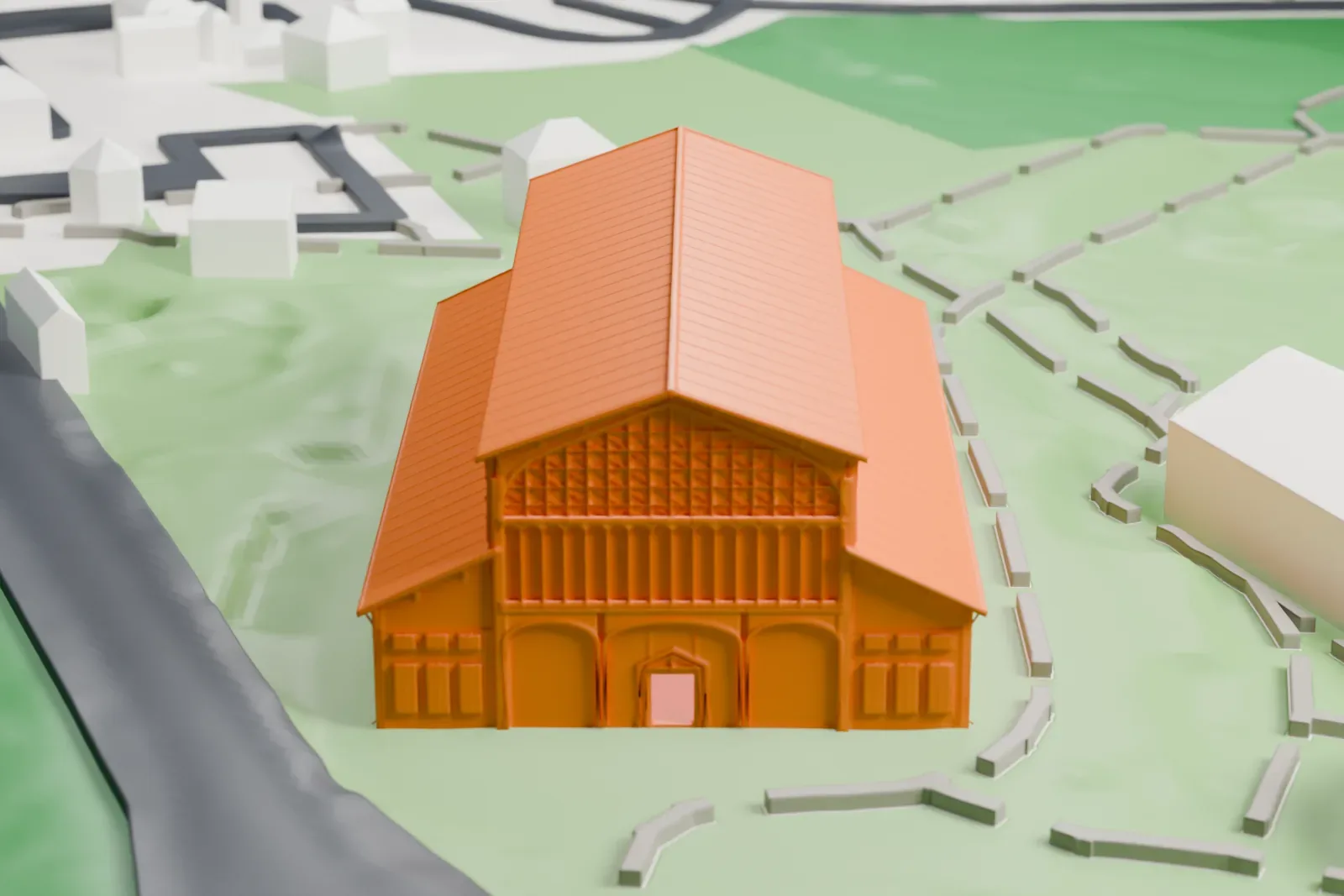 A white 3D print of Hangar Y at Chalais-Meudon, a long hall with a tall central roof, sloping side roofs and a round motif on its gable end, on green ground beside water.