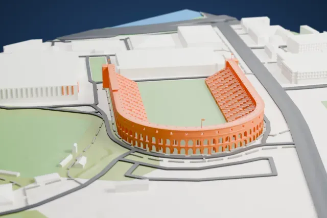 A white 3D print of Harvard Stadium, a U-shaped stadium with an arched outer wall and an open end, beside large buildings and green fields.