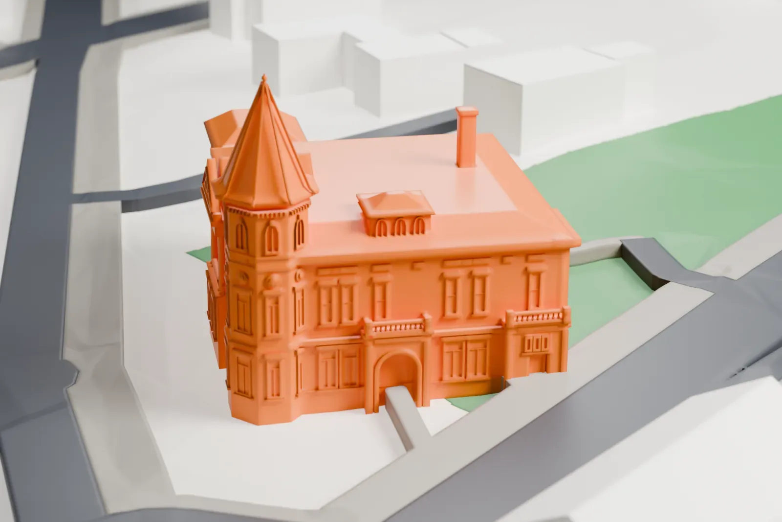 A white 3D print of the Haskell Free Library and Opera House in Derby Line, with the surrounding streets and buildings.