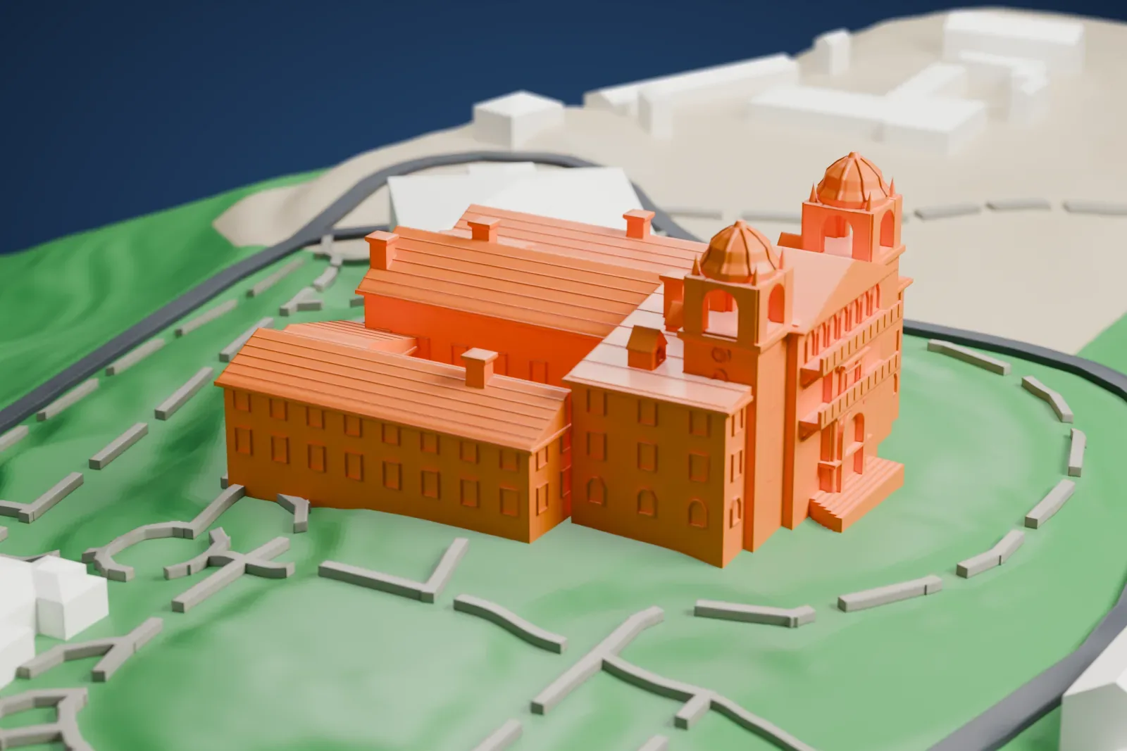 A white 3D print of Hearst Castle, a hillside mansion with two domed bell towers, ridged roofs and an ornate entrance front, surrounded by green slopes, winding paths and smaller buildings.